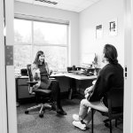 The Assistant Dean of Students talking to a student in her office.